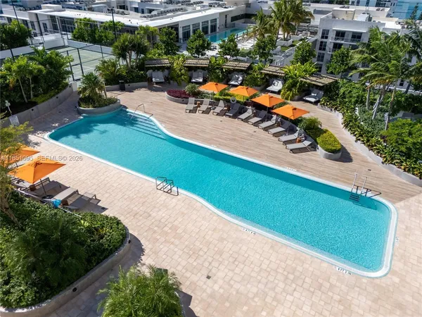 an aerial view of a house with a garden and swimming pool