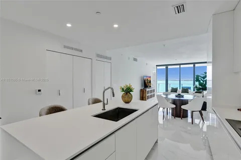 a view of a kitchen area with furniture and floor to ceiling window