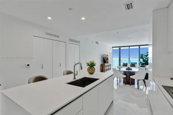 a view of a kitchen area with furniture and floor to ceiling window