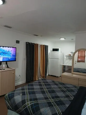 a bedroom with a bed and painting on the wall