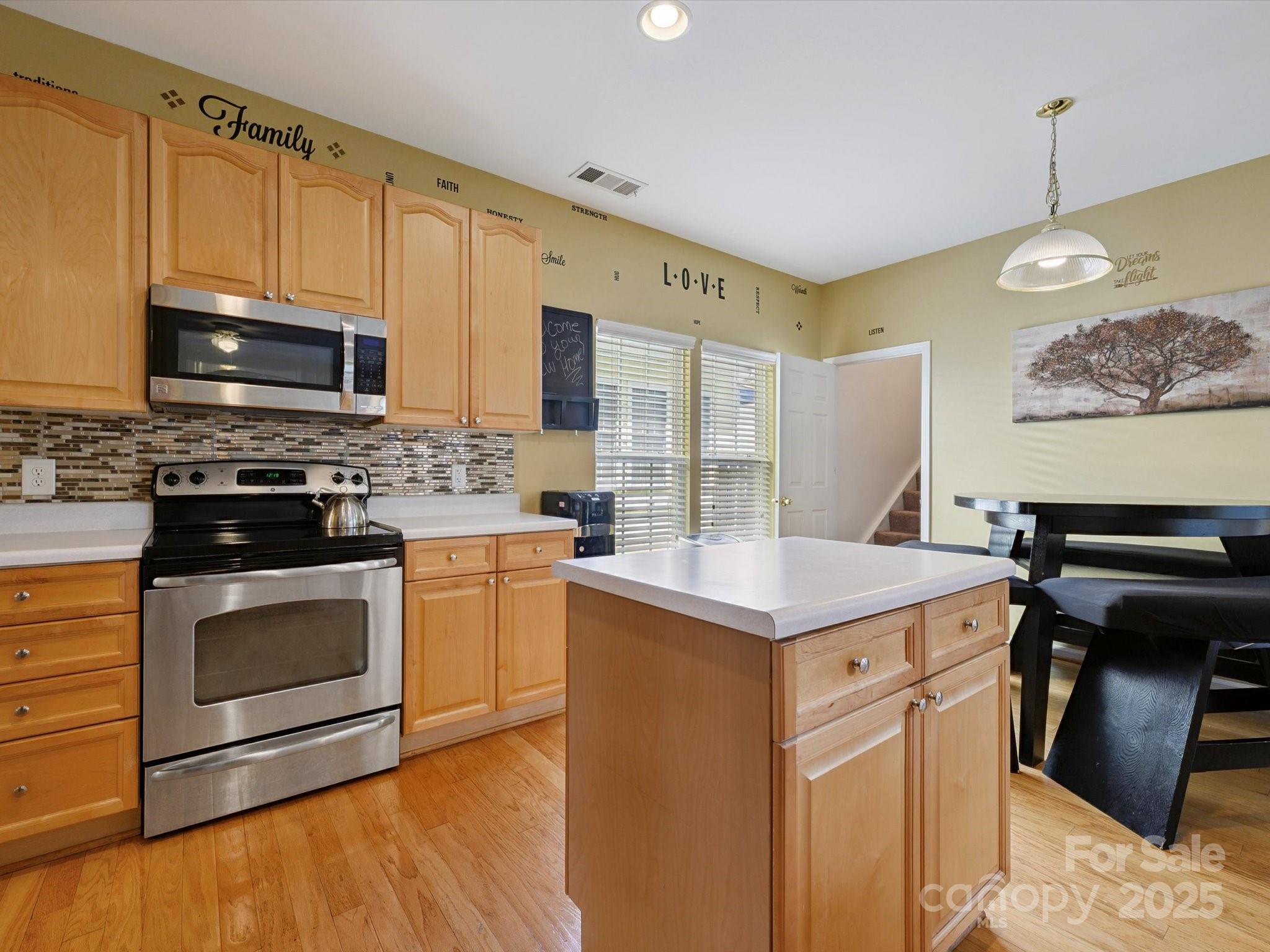 4959 Prosperity Ridge Road Charlotte, NC 28269 - Photo 13 of 40 a kitchen with a stove and a microwave