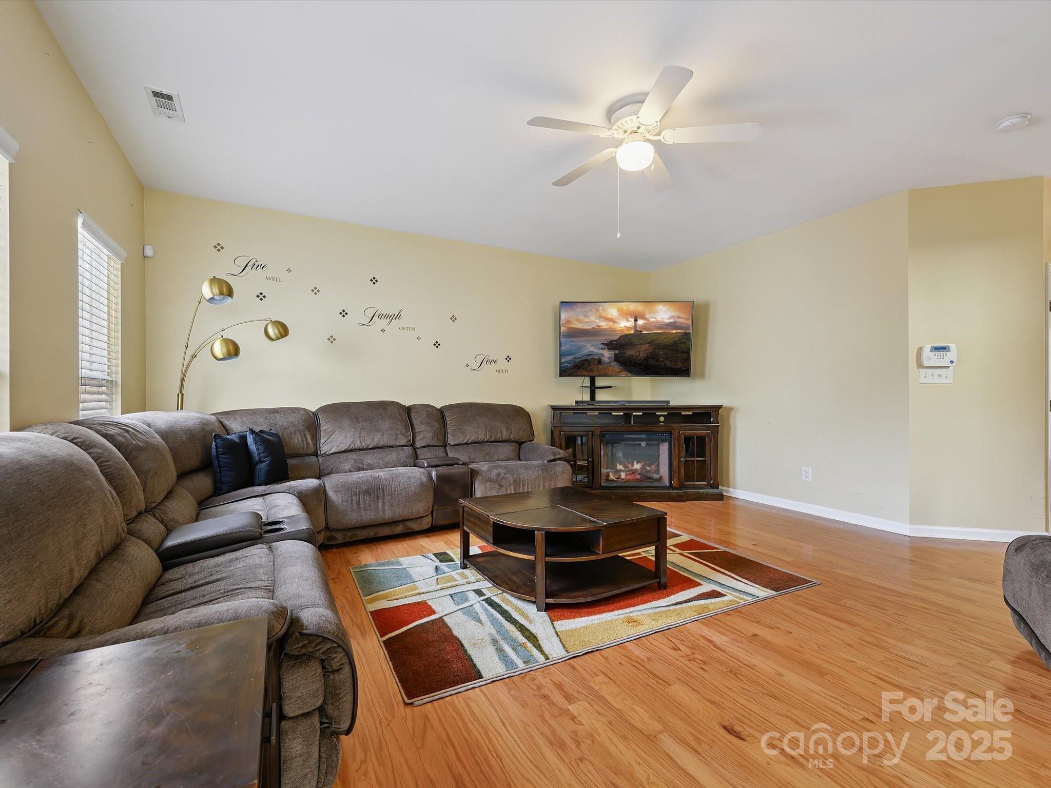 4959 Prosperity Ridge Road Charlotte, NC 28269 - Photo 15 of 40 a living room with furniture and a flat screen tv with wooden floor