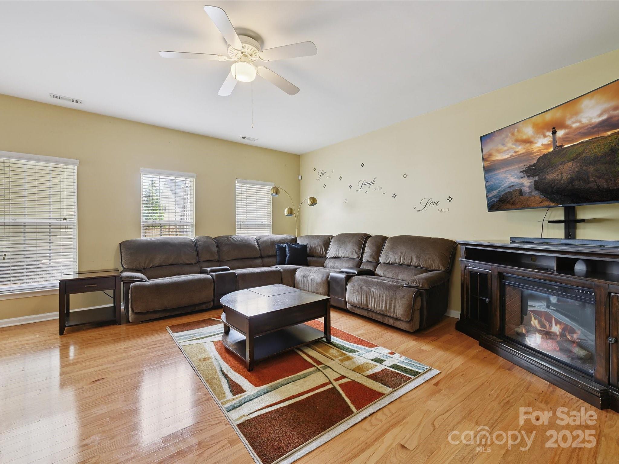 4959 Prosperity Ridge Road Charlotte, NC 28269 - Photo 16 of 40 a living room with furniture a flat screen tv and a rug