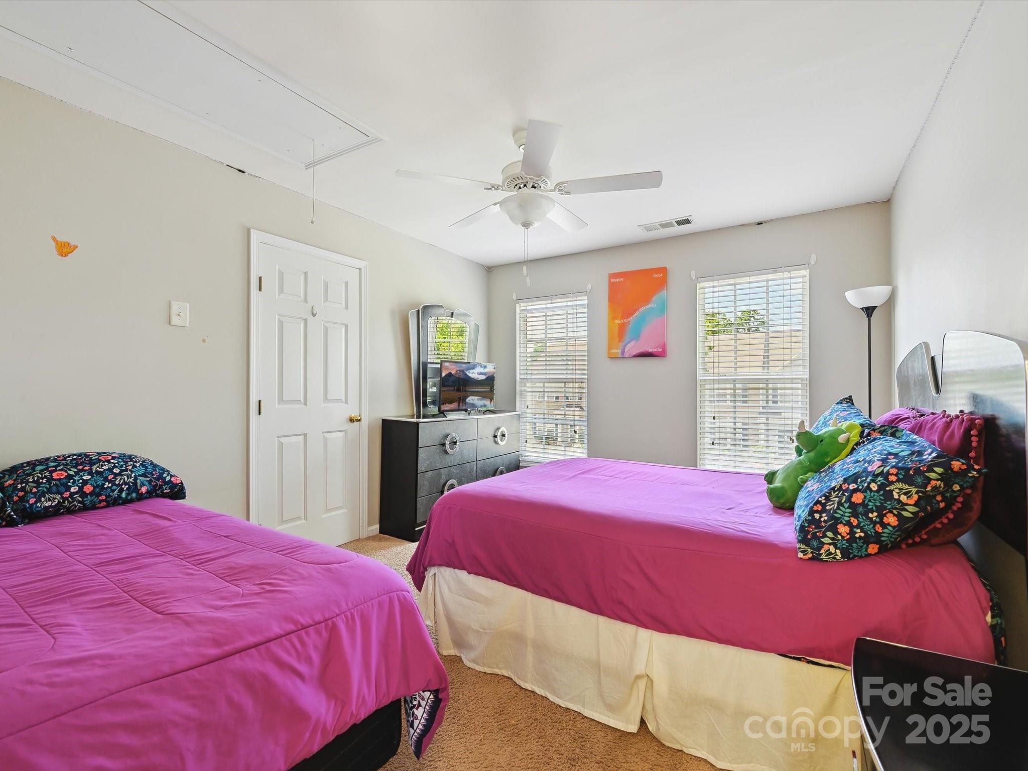 4959 Prosperity Ridge Road Charlotte, NC 28269 - Photo 20 of 40 a bedroom with a bed and a potted plant