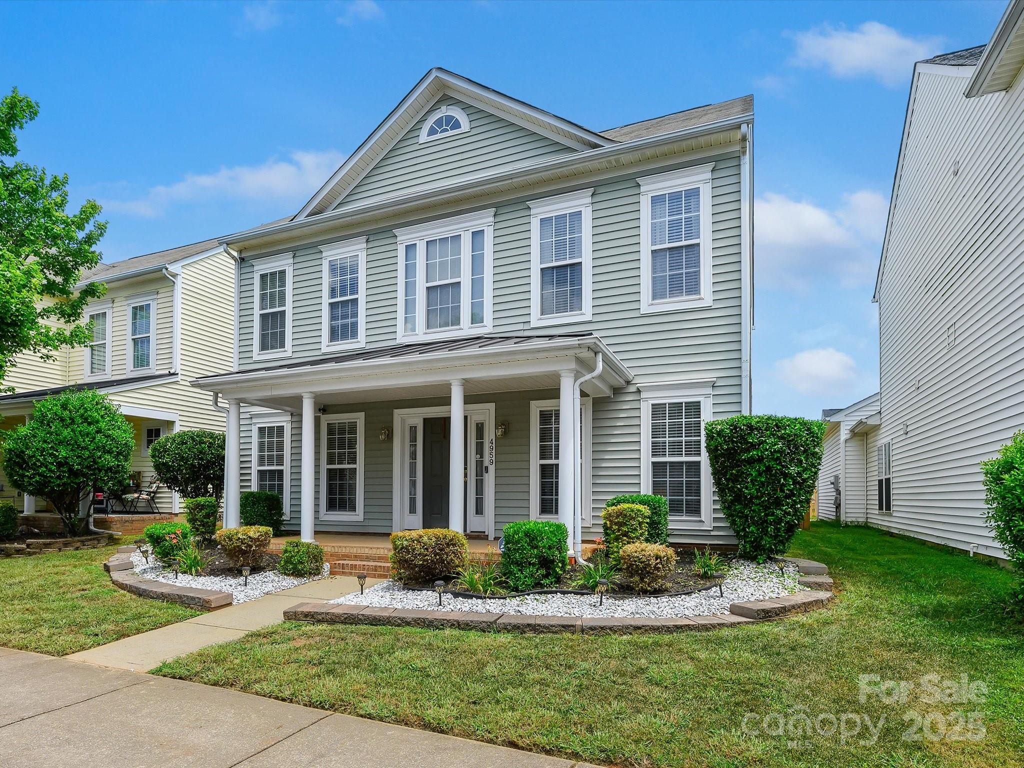 4959 Prosperity Ridge Road Charlotte, NC 28269 - Photo 2 of 40 a front view of a house with a yard and porch