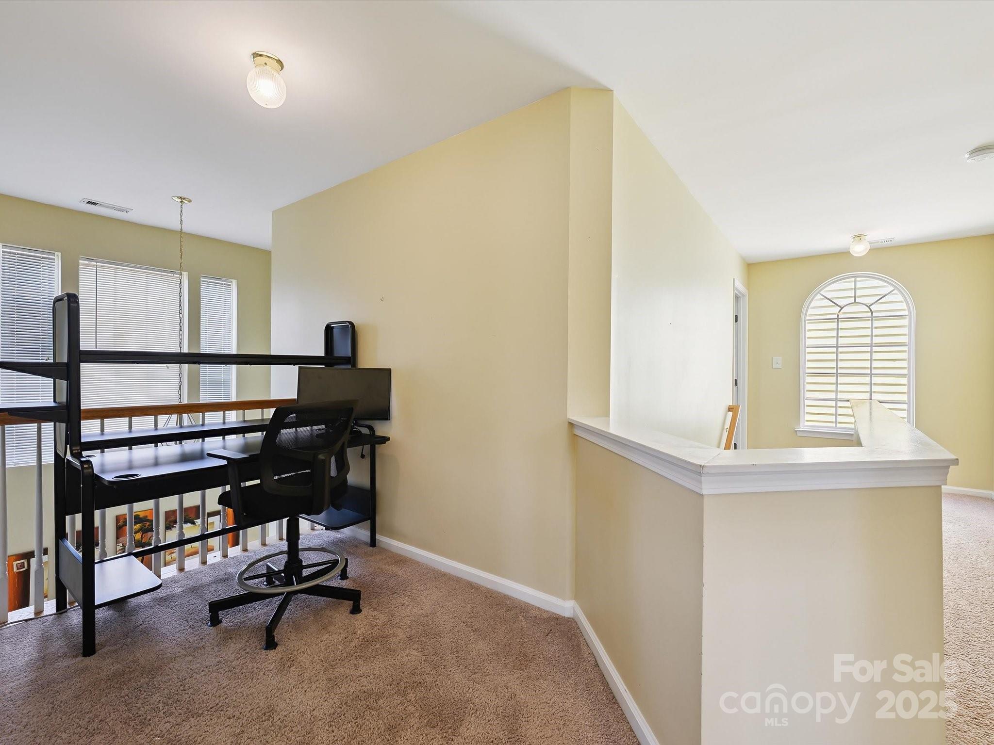4959 Prosperity Ridge Road Charlotte, NC 28269 - Photo 21 of 40 a view of a workspace with furniture and a window