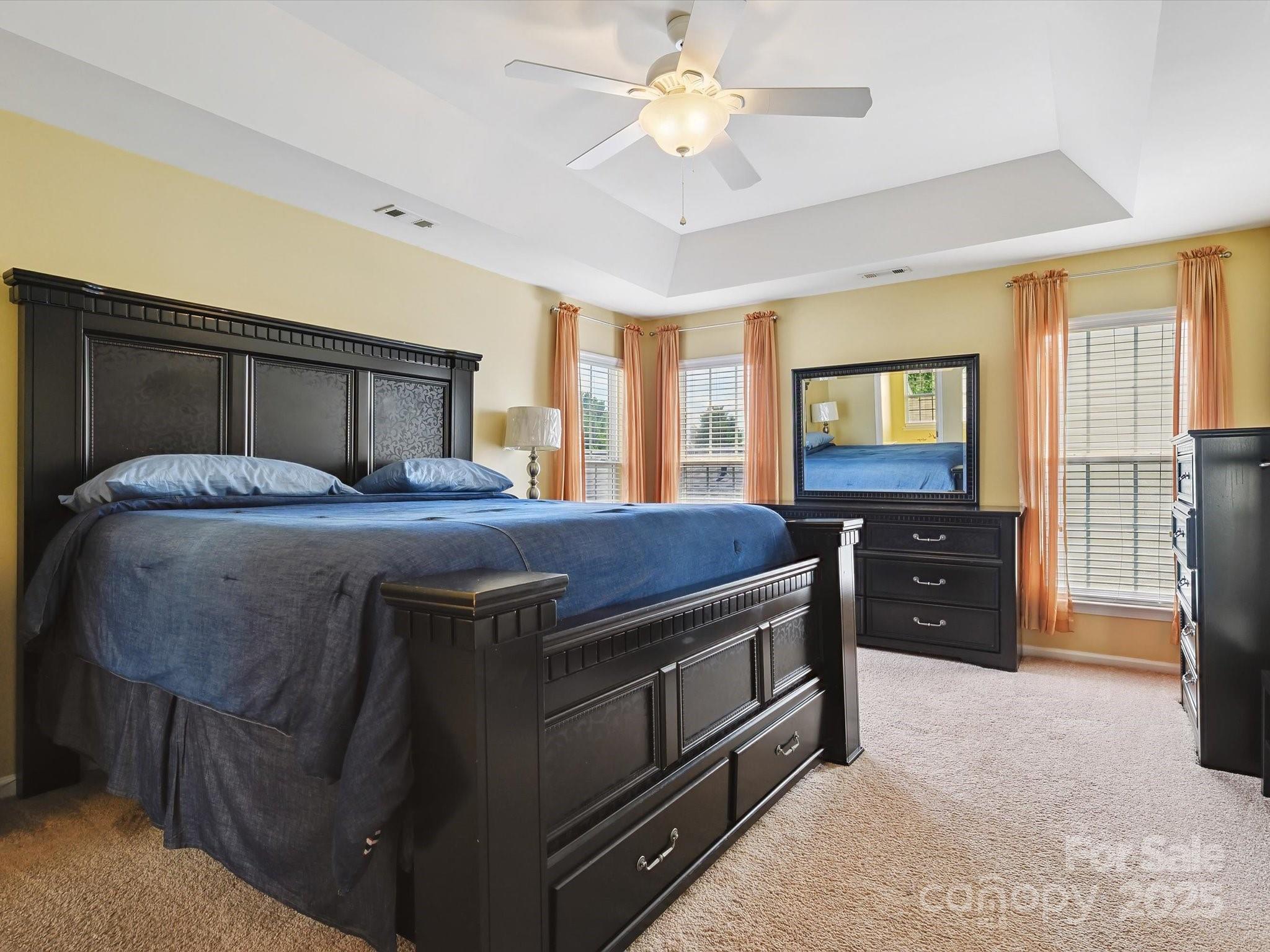 4959 Prosperity Ridge Road Charlotte, NC 28269 - Photo 24 of 40 a bedroom with a bed and a chandelier