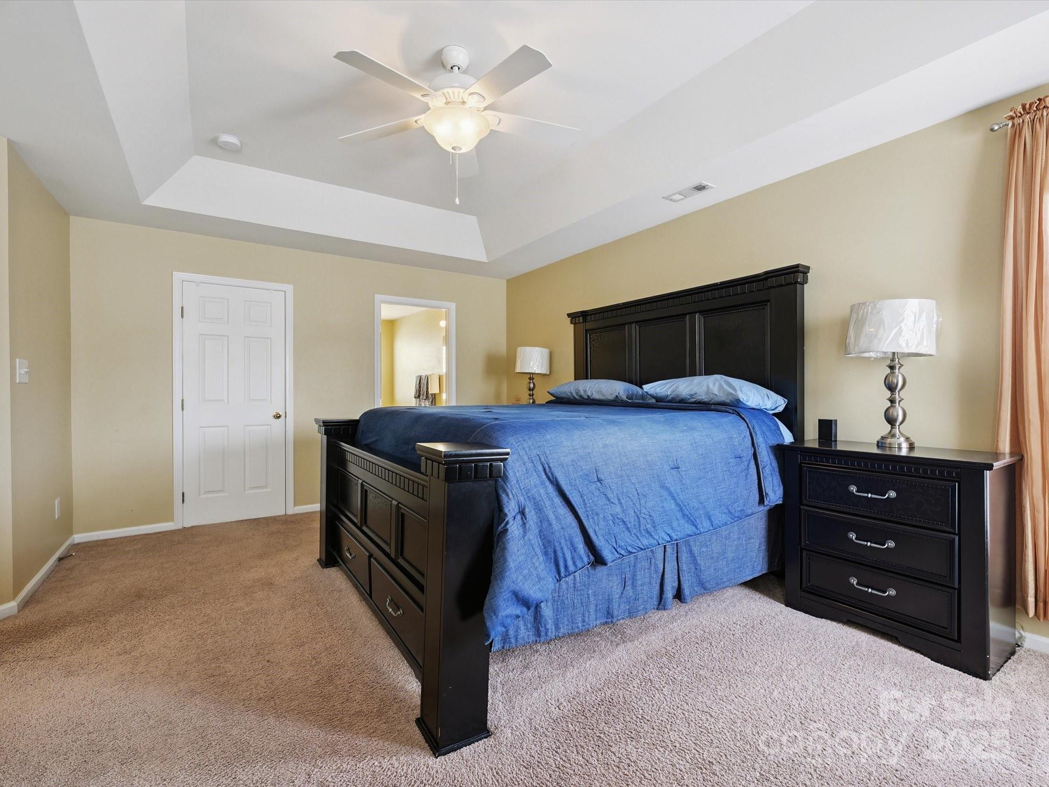 4959 Prosperity Ridge Road Charlotte, NC 28269 - Photo 25 of 40 a bedroom with a bed and a chandelier