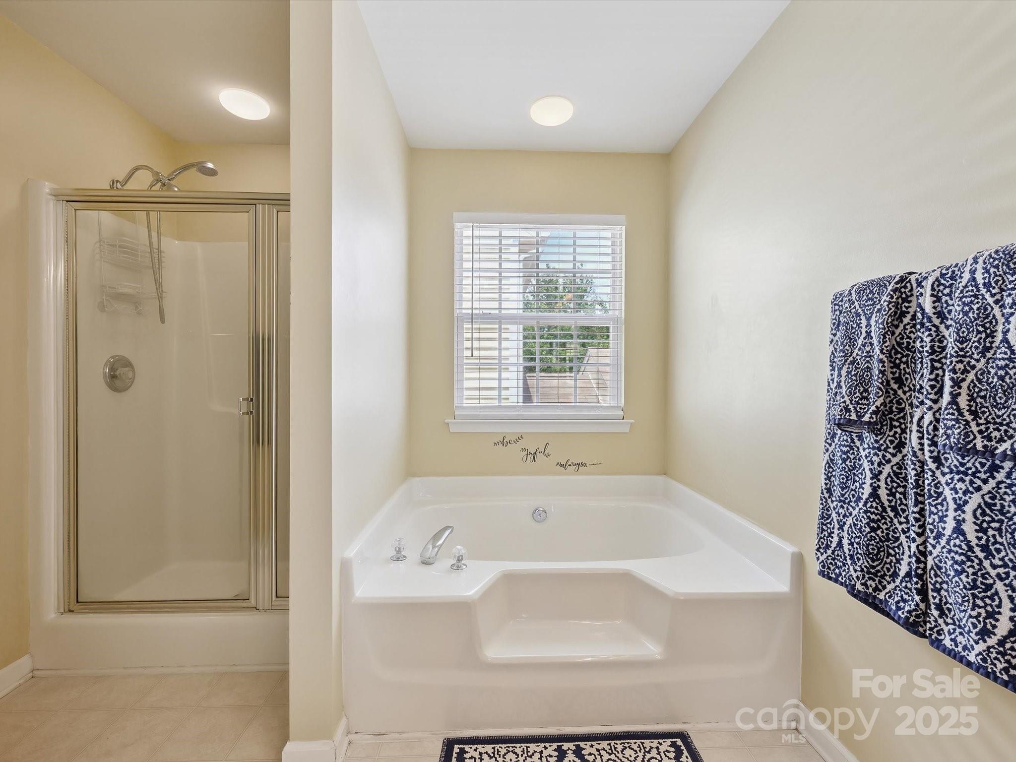 4959 Prosperity Ridge Road Charlotte, NC 28269 - Photo 28 of 40 a bathroom with a bathtub and shower