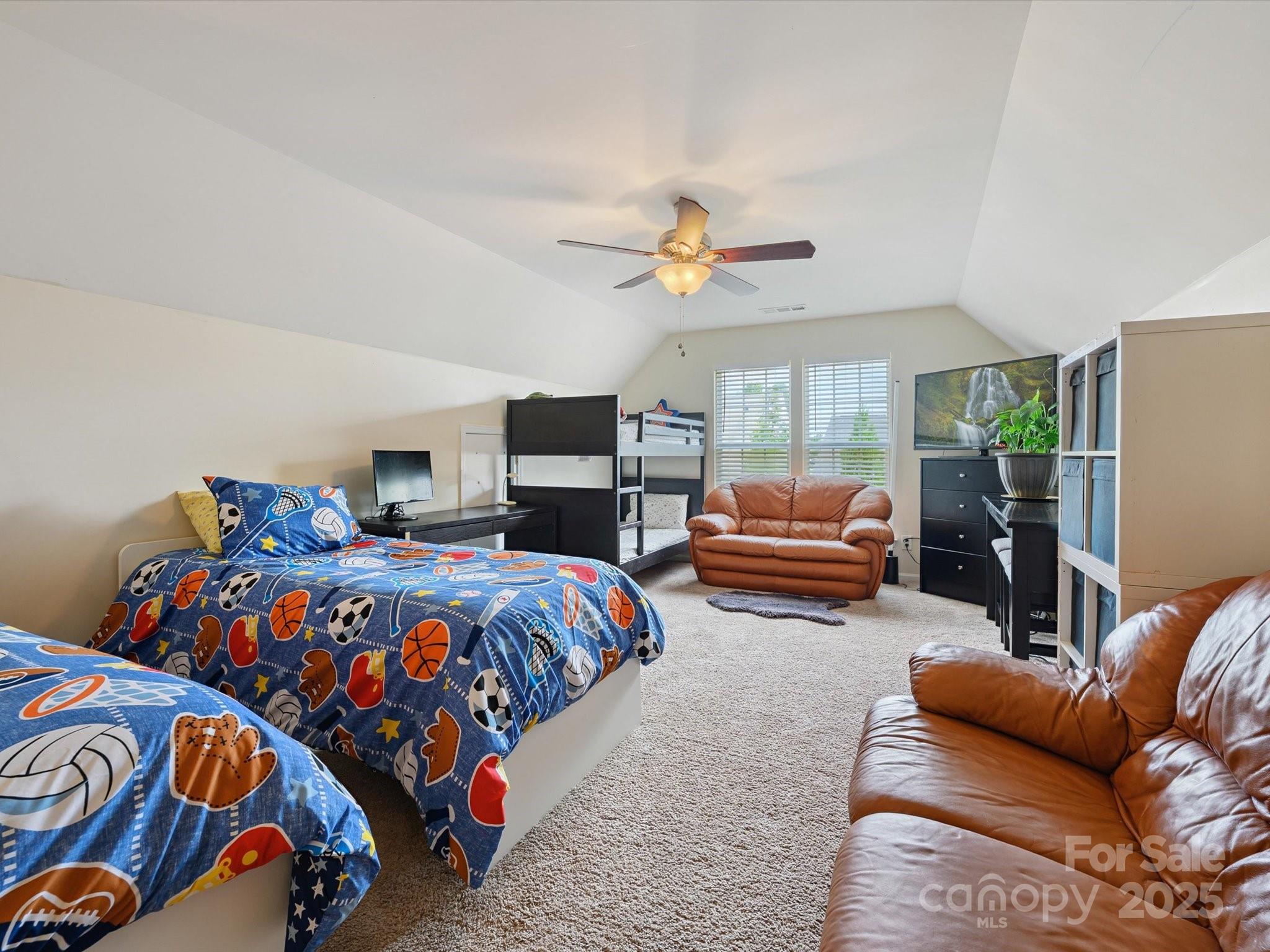 4959 Prosperity Ridge Road Charlotte, NC 28269 - Photo 30 of 40 a bedroom with furniture and a chandelier