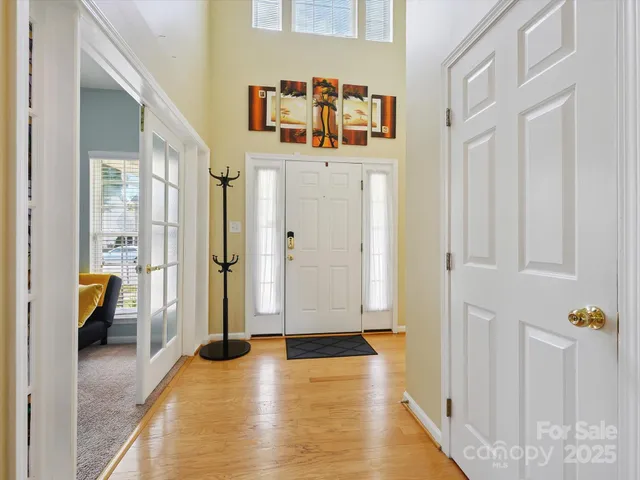 a view of a hallway with bathroom and wooden floor