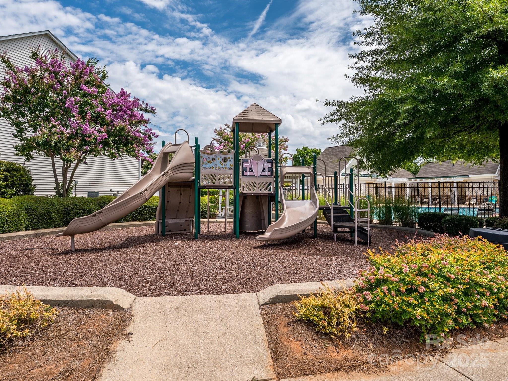 4959 Prosperity Ridge Road Charlotte, NC 28269 - Photo 37 of 40 a view of a park with plants and a bench