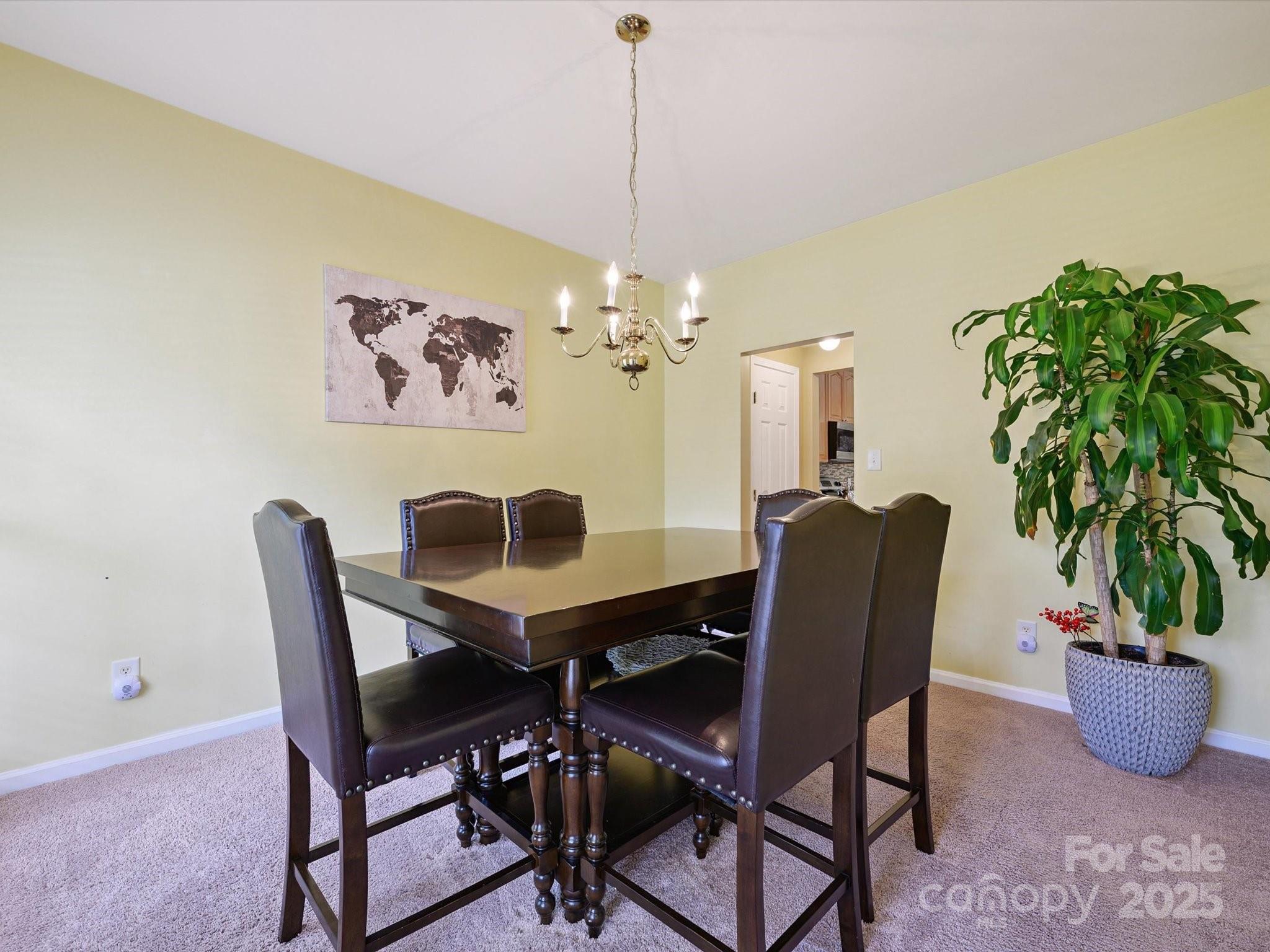 4959 Prosperity Ridge Road Charlotte, NC 28269 - Photo 7 of 40 a view of a dining room with furniture and a potted plant