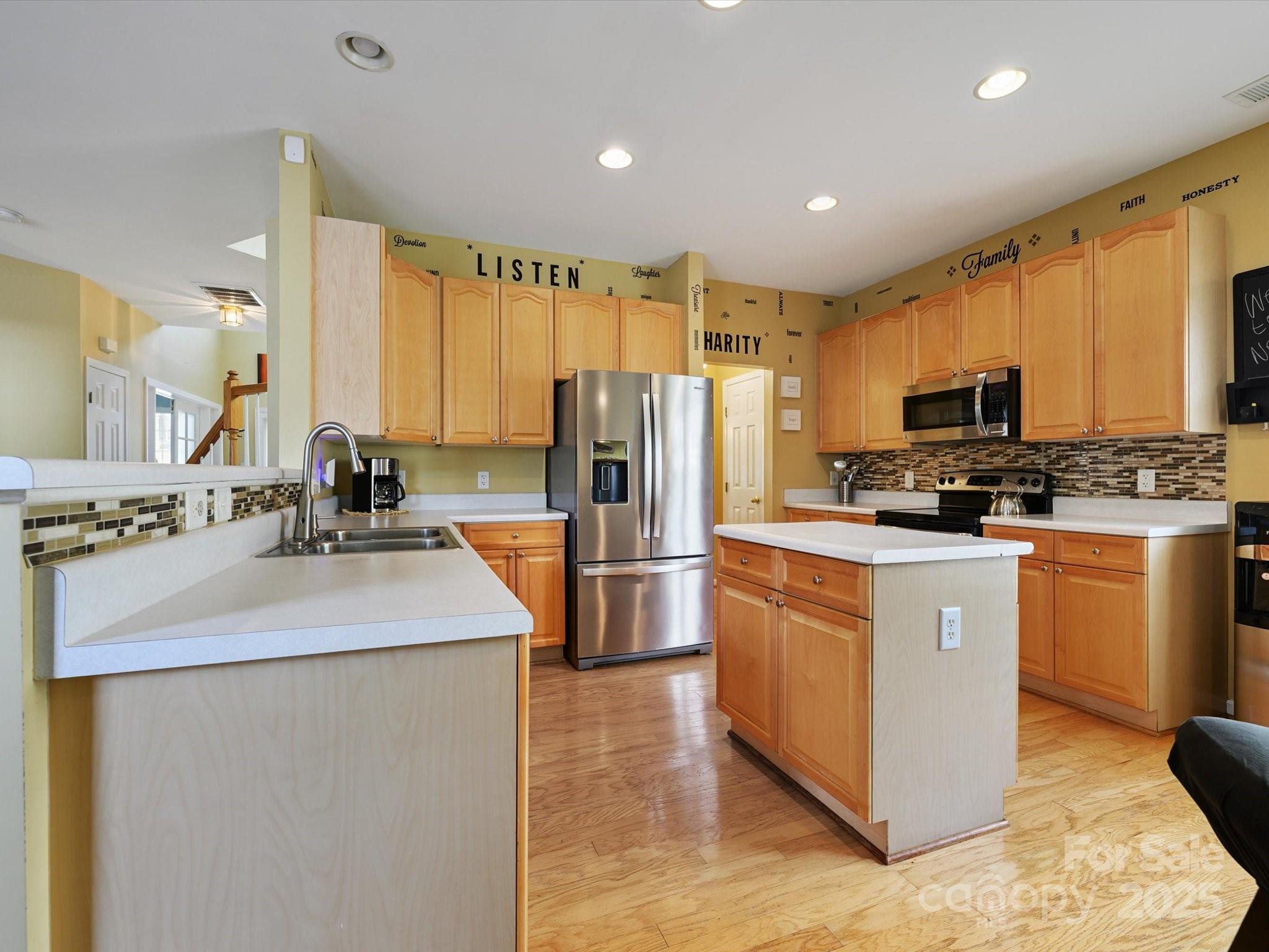 4959 Prosperity Ridge Road Charlotte, NC 28269 - Photo 10 of 40 a kitchen with stainless steel appliances granite countertop a sink stove refrigerator and cabinets
