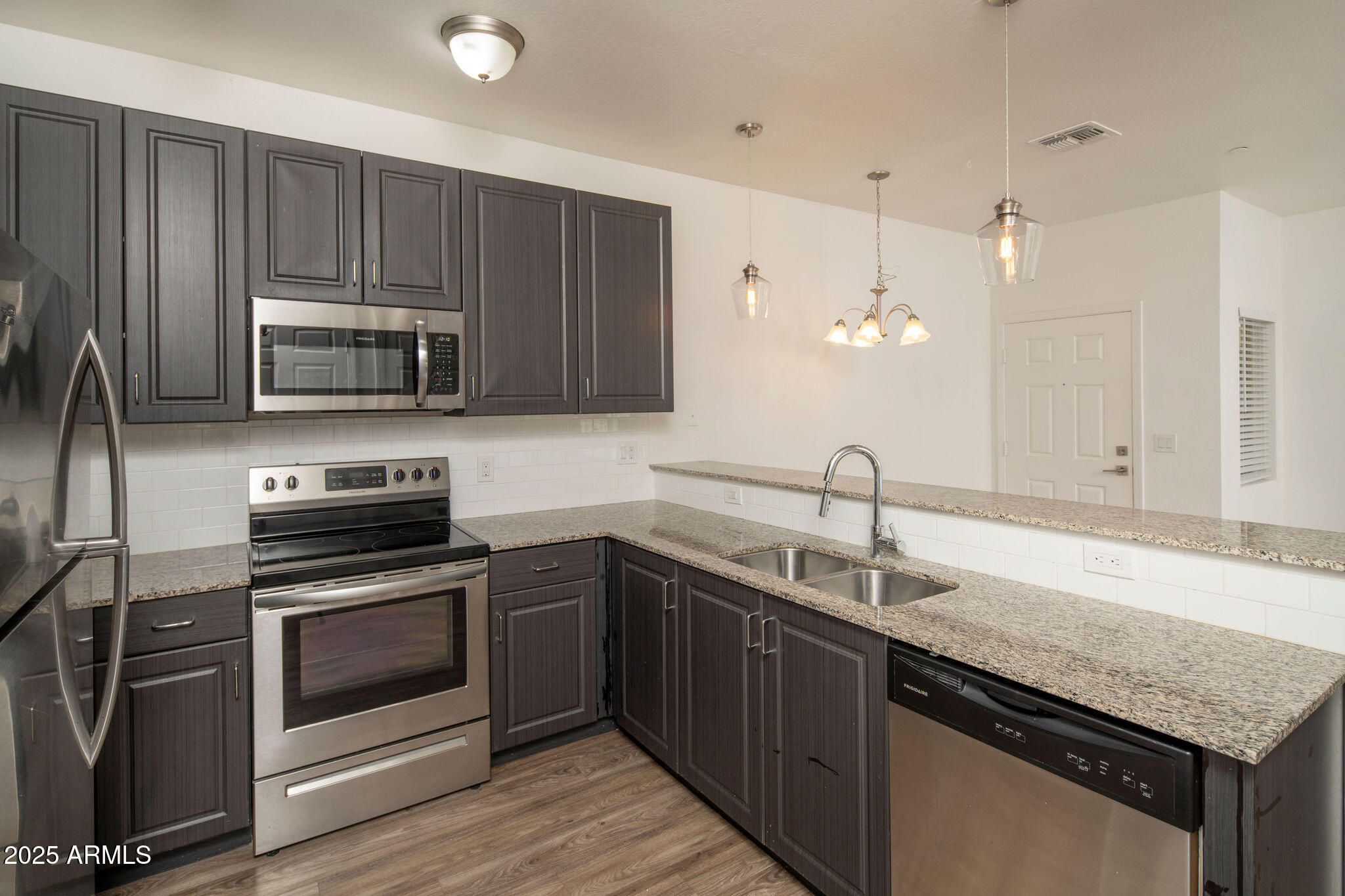 2016 West Orangewood Avenue Phoenix, AZ 85021 - Photo 17 of 22 a kitchen with granite countertop a sink cabinets and stainless steel appliances
