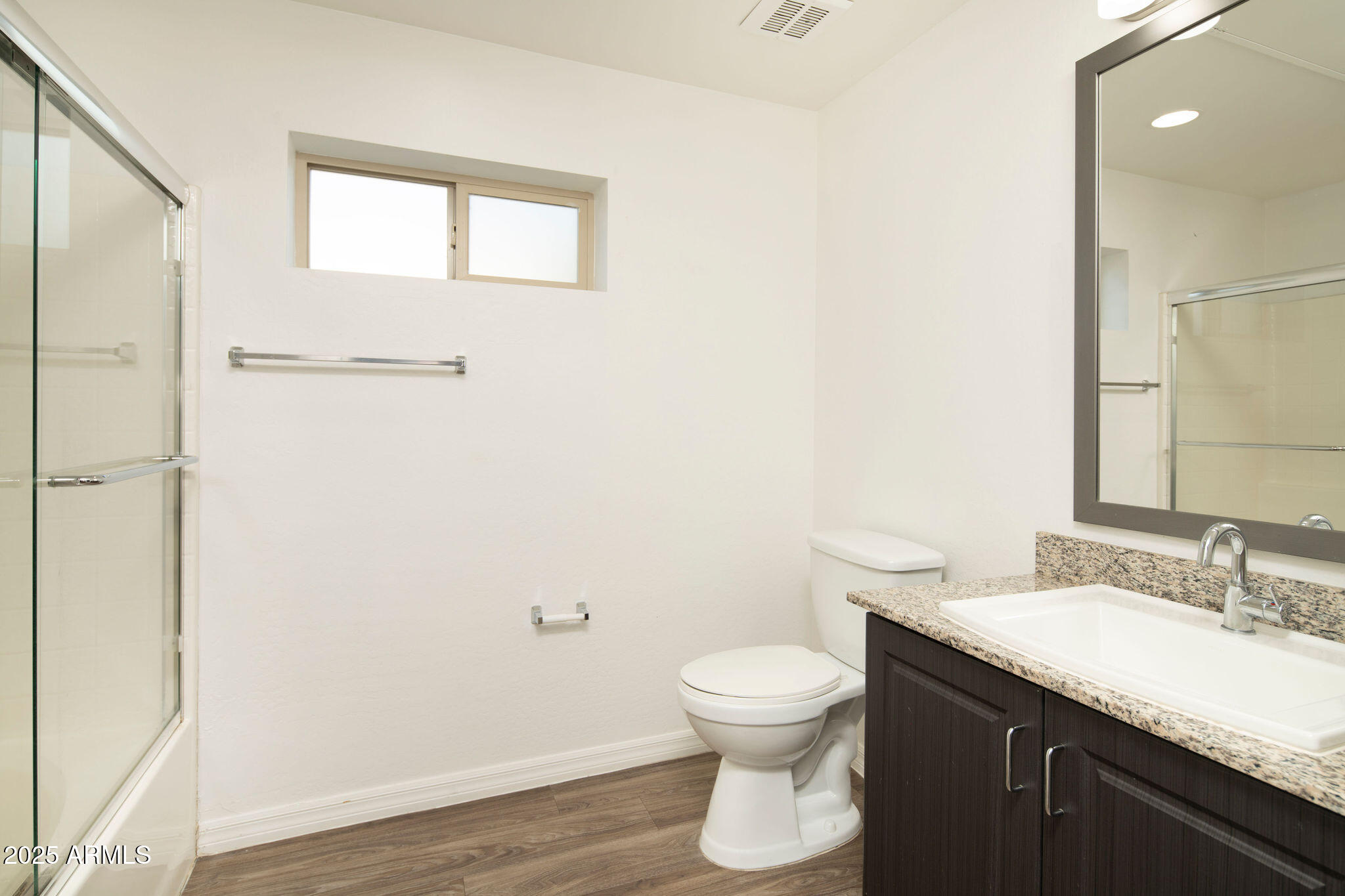 2016 West Orangewood Avenue Phoenix, AZ 85021 - Photo 18 of 22 a bathroom with a granite countertop sink toilet and a mirror