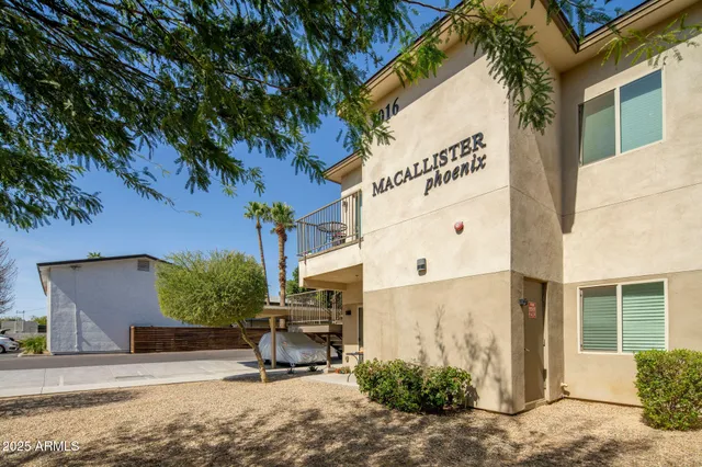 a view of a building with a tree in front
