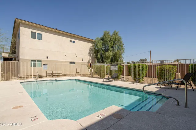 a view of a swimming pool with a lounge chair