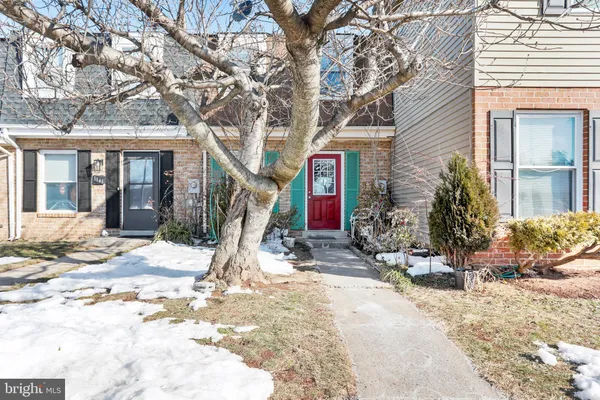 a view of a house with a yard and sitting area