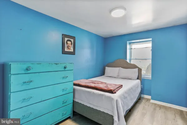 a room with a bed and a night stand