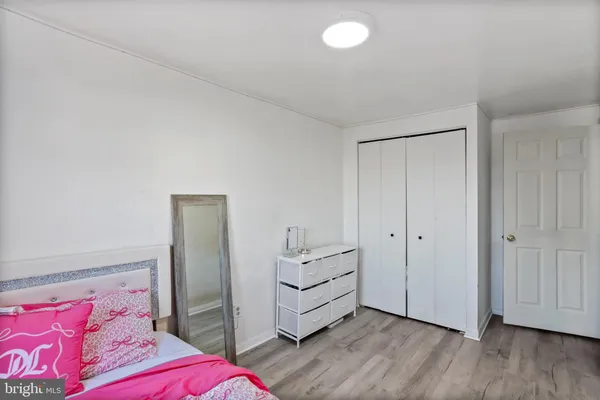 a bedroom with a bed and a potted plant