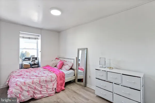 a bed room with a bed and a night stand