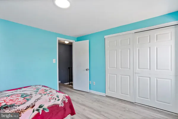 a bedroom with a bed and a mirror