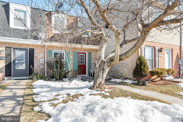 a view of a house with snow on the road