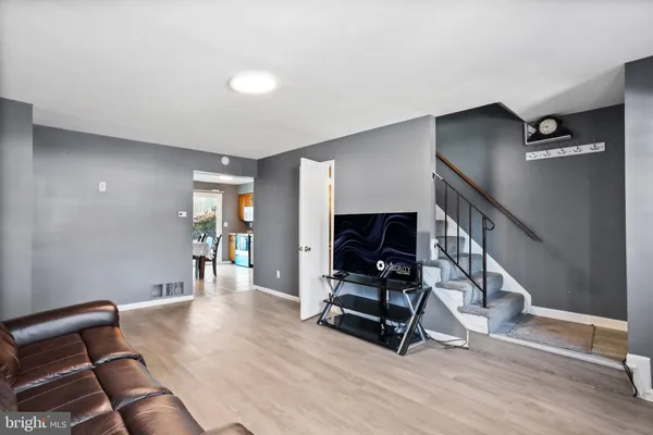 a view of a room with gym equipment and wooden floor
