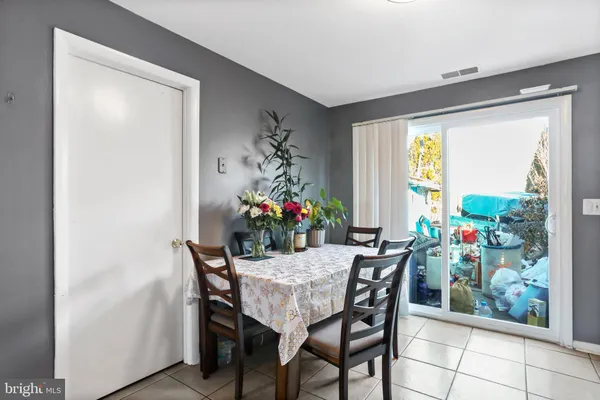 a view of a dining room with furniture and a potted plant
