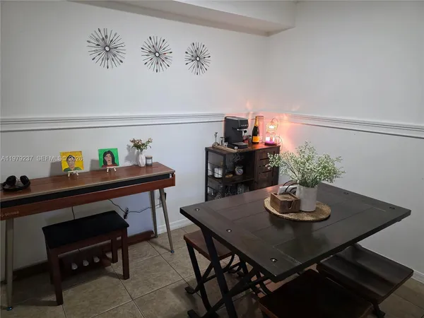 a balcony with couple of chairs and wooden floor