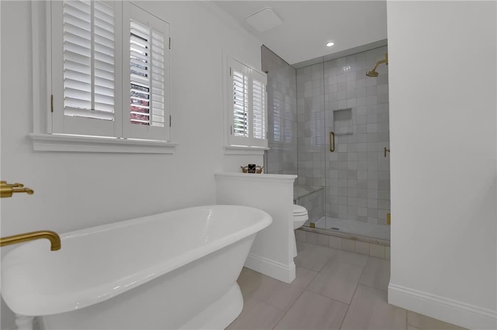 2602 Tanglewood Road Decatur, GA 30033 - Photo 21 of 37 a white bath tub sitting in a bathroom next to a window