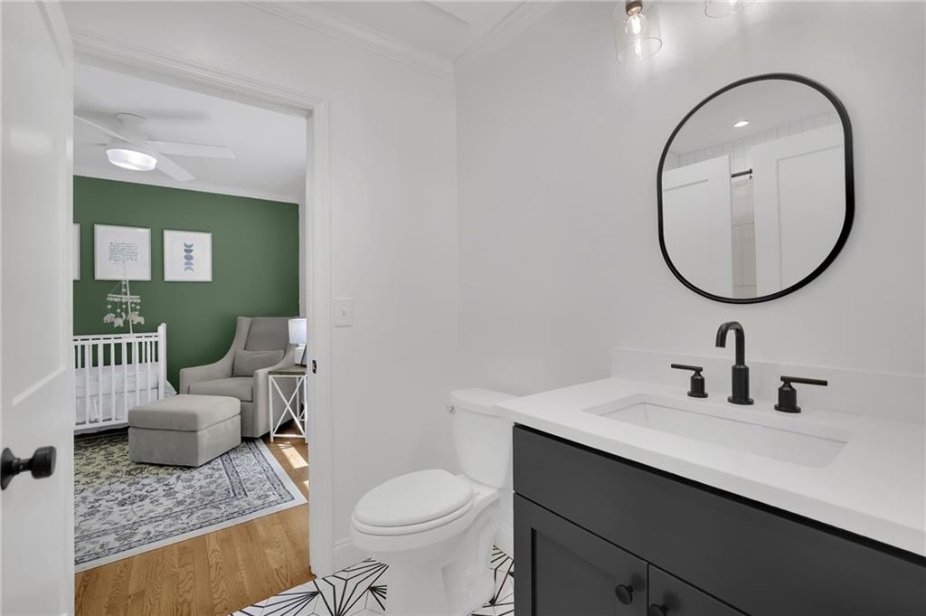 2602 Tanglewood Road Decatur, GA 30033 - Photo 26 of 37 a bathroom with a granite countertop toilet a sink and a mirror
