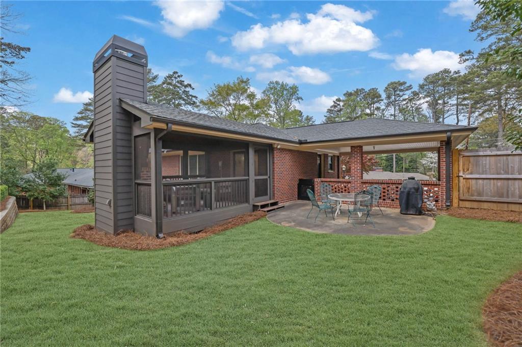 2602 Tanglewood Road Decatur, GA 30033 - Photo 32 of 37 a view of a chair and table in back yard of the house