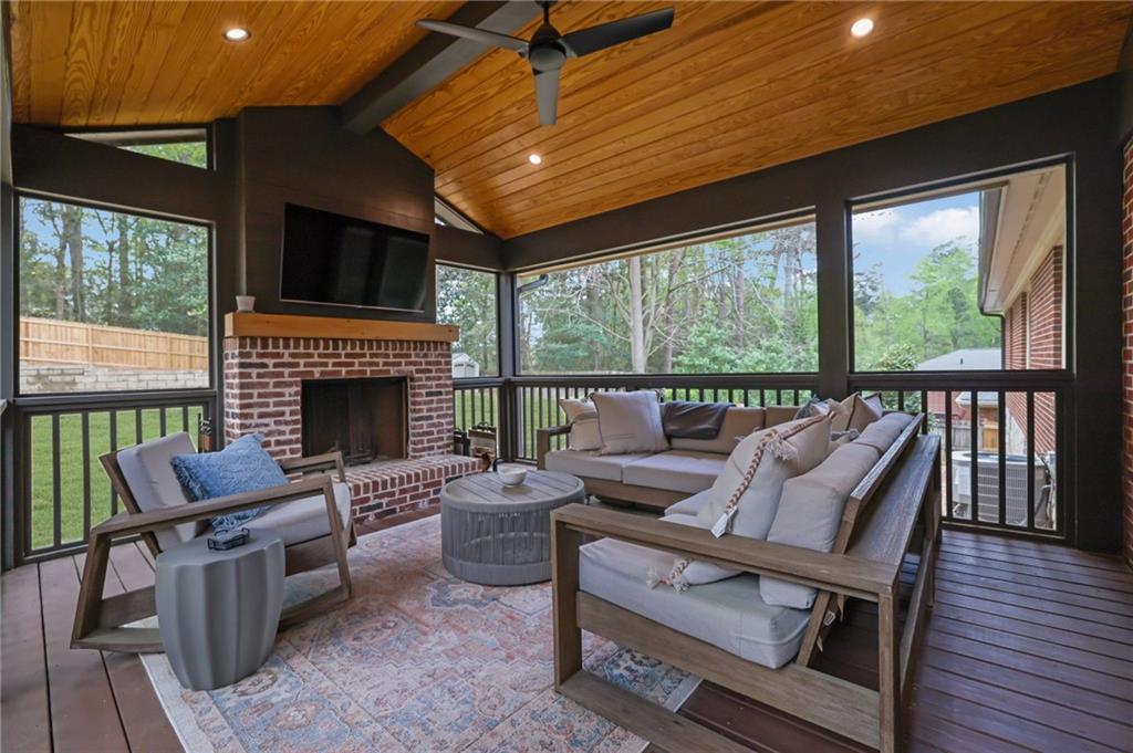 2602 Tanglewood Road Decatur, GA 30033 - Photo 34 of 37 a living room with furniture a flat screen tv and a fireplace