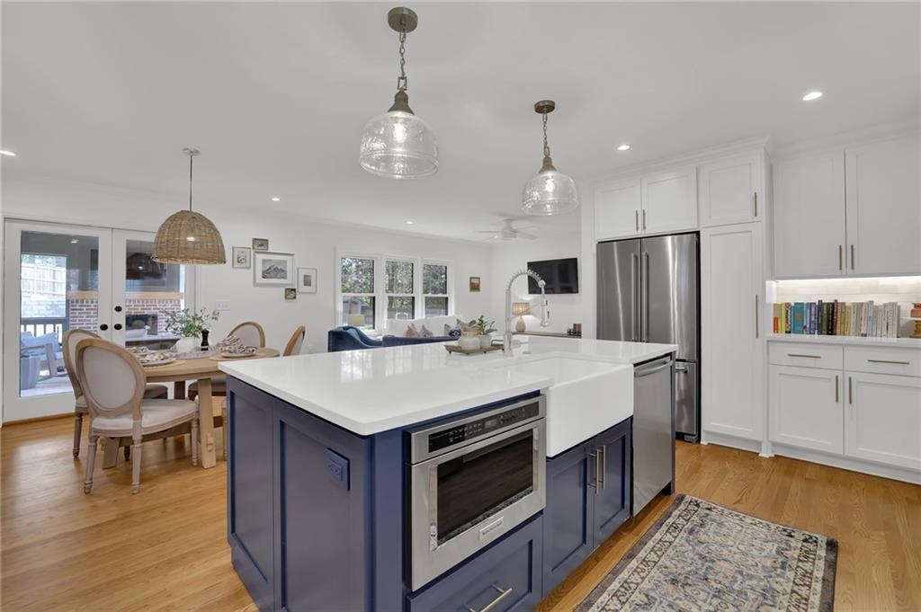2602 Tanglewood Road Decatur, GA 30033 - Photo 6 of 37 a kitchen with a stove a refrigerator and a dining table with wooden floor