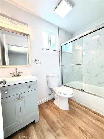 a bathroom with a toilet sink a mirror and a shower