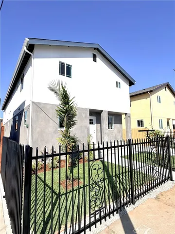 a view of a house with wooden fence