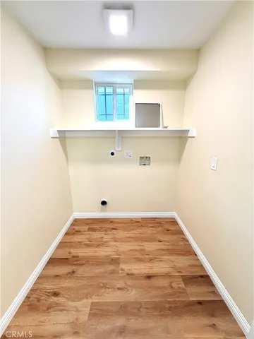 a view of a room with wooden floor and cabinet