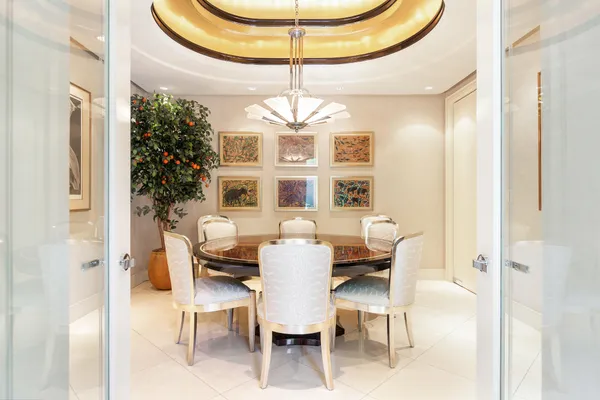 a dining room with furniture a chandelier and window