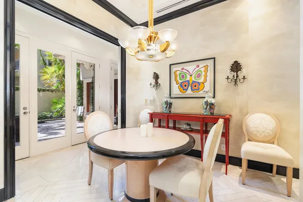 a view of a dining room with furniture and a chandelier