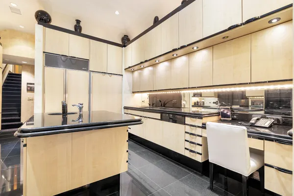 a kitchen with a sink a stove and cabinets