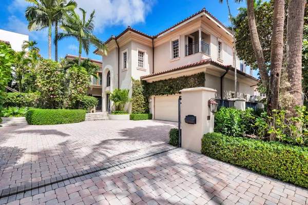 a front view of a house with a yard and a garage