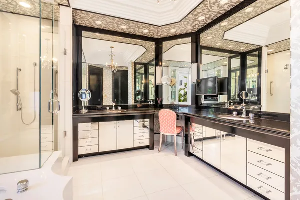 a large white kitchen with a large window