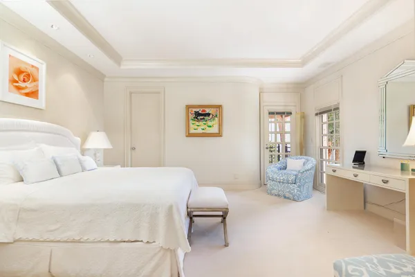 a bedroom with a large bed and a couch