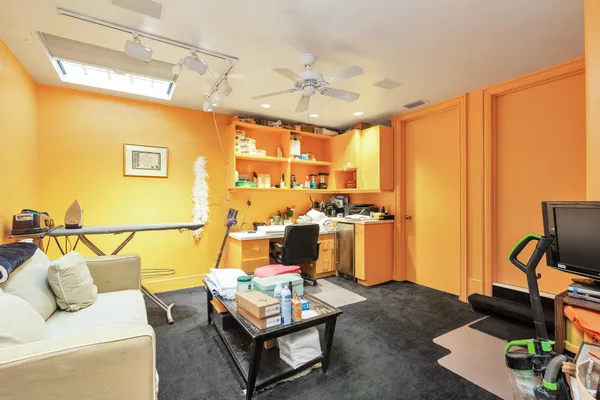 a living room with furniture a flat screen tv and a window