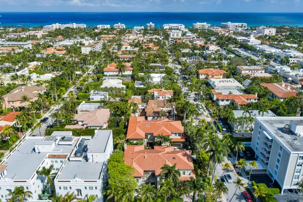 an aerial view of residential houses with outdoor space and street view