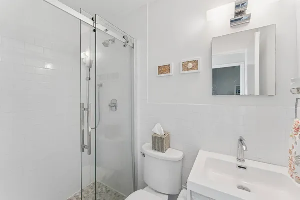 a bathroom with a toilet sink and shower
