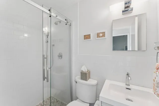 a bathroom with a toilet sink and shower