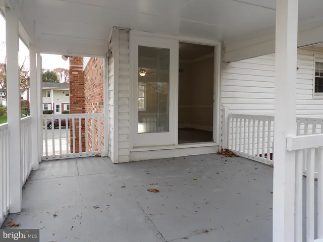 a view of a porch with a floor to ceiling window